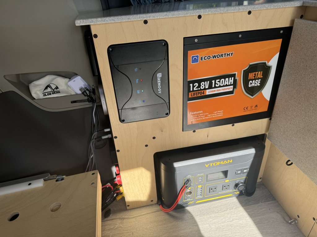 Electrical module cabinet in a Toyota Sienna minivan camper with an Eco-Worthy metal case battery, Renogy charger and portable power station